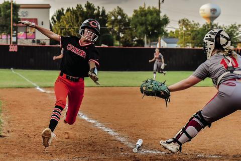 Harli York does a great job avoiding the tag-out at home. Photo by Sarah Townes