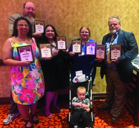 Cimarron Valley Communications staff stand with their first place plaques following the Better Newspaper Contest awards banquet Saturday, June 6 held at the Embassy Suites in Norman. Pictured back row advertising director Jeremy Fincher, middle row lead reporter DeAnna Maddox, accounts and office manager Sapphire Smith, managing editor Allie Prater, owner and publisher J.D. Meisner, front row chief moral officer Jamison Prater. Photo by Caleson Coon.