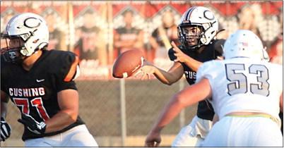 Cushing Tiger Quarterback John Hilligos takes the snap. Photos by Allie Prater.