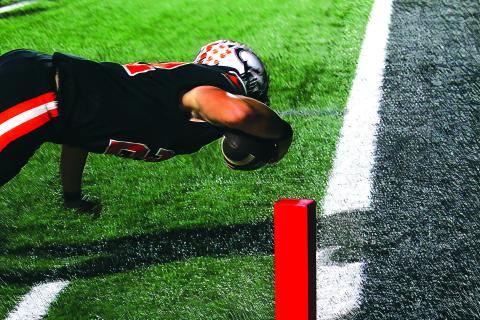 Wyatt Heisler makes a diving touchdown in the second quarter of last weeks win over Ft. Gibson. Photo by J. D. Meisner