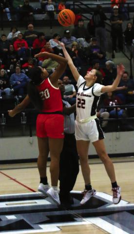 Lady Tiger Ella Nanaeto contests the opening tip against Perkins’ Brynn Stone Friday.