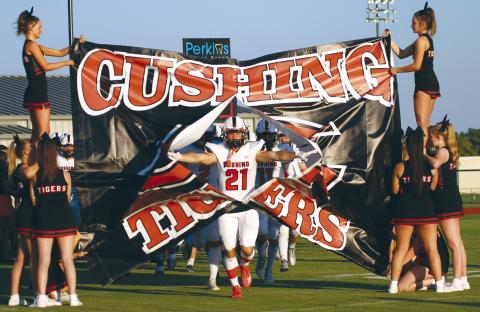 Tiger receiver Camden Crooks breaks through the signs at Perkins Friday