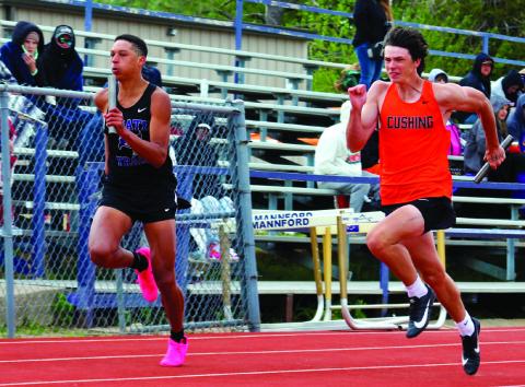 Mannford’s Ryan Owens and Cushing’s Brison Stewart go head-tohead in the 4x100 meter relay.