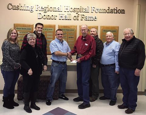 Cushing Masonic Lodge Worshipful Master Sean Martin presents a check for $5,279.70 to Lee Roy Kalka, Cushing Regional Hospital Foundation president. The funds will be used to help pay tuition for Cushing firemen who want to attend Central Tech's paramedic certification program. Pictured (from left) are: Latina Simmons, Pam Hawthorn, Matt Turner, Sean Martin, Lee Roy Kalka, Justin Stewart, Mike Harris and Joe Manning.