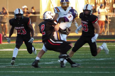 Cushing Tiger Lane Yaunt brings down Bristow ball carrier Jon Montgomery Friday, while Tiger defenders Noah Jones and Riley Matheson look on. The Tigers scuttled the Pirates 63-20 and held Bristow’s offense scoreless until late in the third quarter. Photo by J.D. Meisner