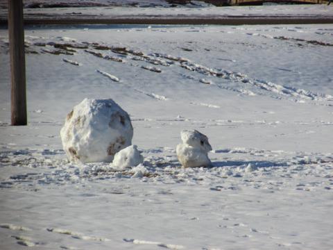 Time honored tradition of building snowmen 