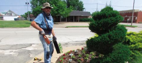 Ben Welch works on the plant beds on the north side of BlueSky Bank. Photo by DeAnna Maddox