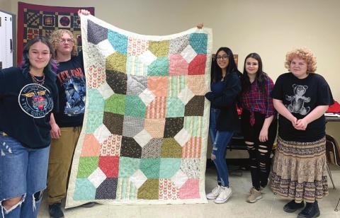 Students of the CHS Fashion and Design class proudly holds a quilt they created. The quilt is the result of a class project and will be donated to Citizens Caring for Children. From left: Chloe Hallabaugh, Jacob Camren, Diana Flores, Jenna Mckinney, and Jasmine Norman.