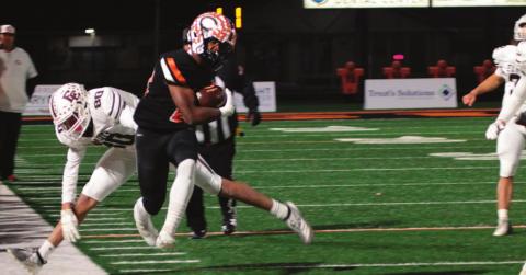 Noah Jones leaps to stay inbounds as he heads up the sidelines.