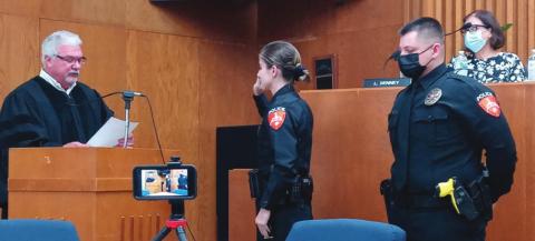 Officer Heather Snow is sworn in by Judge Ahrberg while Officer Jason Beal awaits his swearing in during the City of Cushing commissioner meeting on Monday, Sept. 20.