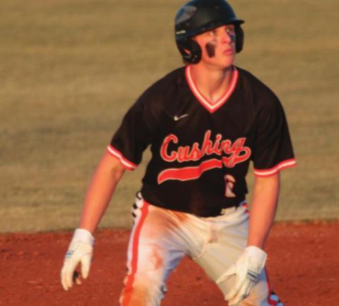 Tiger runner Chantz McBride watches a fly ball from second base Thursday in the Tigers’ home opener against the Tecumseh Savages.