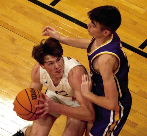Lane Yaunt muscles up a shot in the paint. Photo by J.D. Meisner