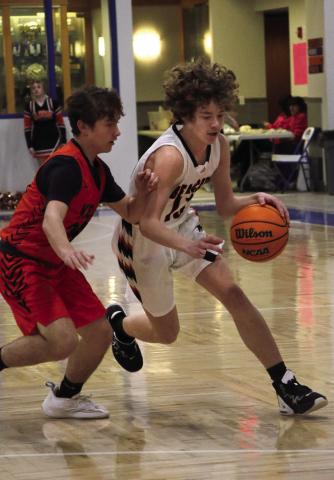 Agra Bearcat Landon Toles drives past a Yale defender during the Bearcats game against the Bulldogs at the Glencoe “Coaches vs Cancer” Tournament this past weekend. Photo by Allie Prater