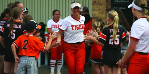 Freshman Talyn Minney is all smiles as she is welcomed onto the field by Cushing Tiger youth athletes. Photo by Allie Prater.