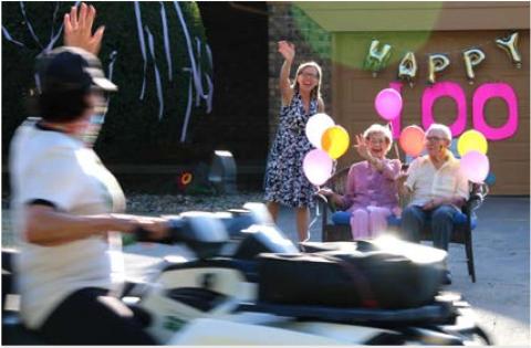 Cathy Reimeck, Hazel Cusac and Jake Amberg enjoy Hazel’s 100th Birthday parade.