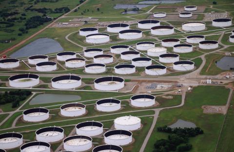 Oil storage tanks at the Cushing hub sit at low capacity. Each tank has a floating lid that rises and falls with the oil inside to prevent product evaporation and buildup of explosive gasses in the headspace. Oil investors and oil market intelligence firms monitor the height of these lids to determine how much oil is in each tank. A lower lid indicates less oil in storage. Photo by Caleson Coon.