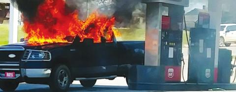 A truck burns at the Yale Mini Supermarket Wednesday after being allegedly set ablaze by its owner.
