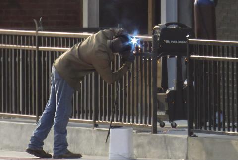 A welder works on the railing of the outdoor patio of Godofredo’s Thursday, July 25. This is part of a larger expansion project that has been ongoing in Downtown Cushing for several weeks. Photo by DeAnna Maddox.