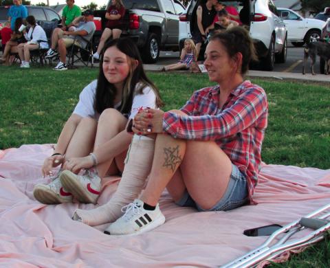 Reanna and Annie Lansford grabbed a blanket and took a spot in the grass to watch the firework display put on by Cushing Fire Department in Memorial Park on July 4.