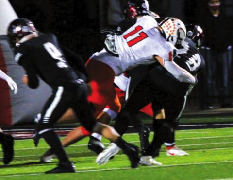 Tiger middle linebacker, senior Hayden Fry, penetrates the Wagoner line untouched and puts a hit on a Wagoner ball carrier. Fry had 13 tackles on the night, with 6 solo. He had an impressive season total of more than 180 tackles.