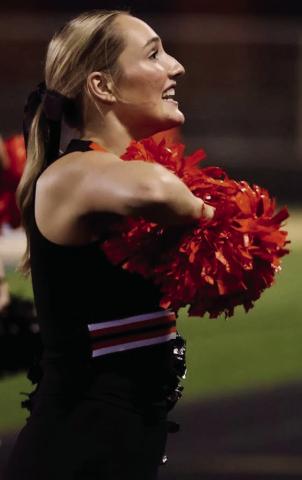 Senior Tiger cheerleader Emery Turner hypes up the crowd during the Friday’s thrashing of Oologah. Photo by Sylvia Danyele