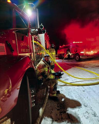 Right: Members of the Ingalls Volunteer Fire Department man the pumper during a fire that broke out in Ripley on Monday.