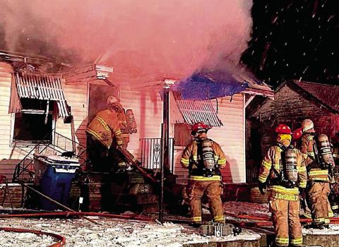 Brett Lunsford and Lucas Andrews makes their way into the primary structure followed by department members Austin Riley, Jesse DeShazer, and Nick Rockhold as billows of smoke ascend and snow descend.