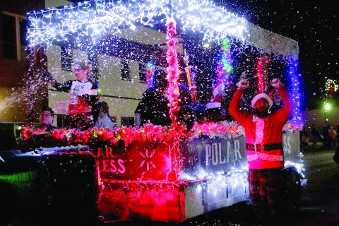 Cushing Wal-Mart associates celebrate their win of Mayor’s Choice in front of the grandstands during the Cushing Christmas Parade Saturday, Dec. 14. Photo by Allie Prater