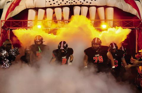 Lane Simpson, Jordan Kersey, and Tye Lucio emerge from the fog, leading the Tigers onto the field Friday for the last regular season home game. Photo by Sylvia Danyele.