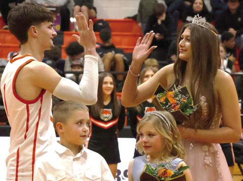 2026 CHS homecoming King Roman Tucker and Queen Tirzah Wade high five after being crowned CHS Basketball Royalty. See inside for more. Photo by Sylvia Danyele.