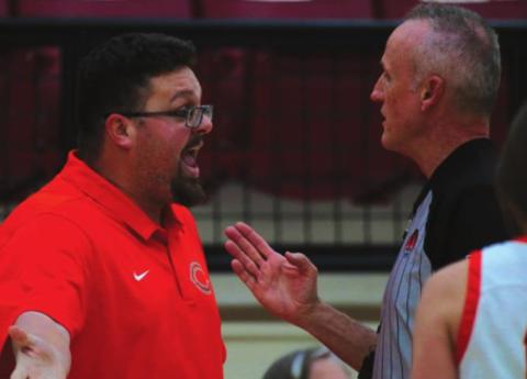 Lady Tiger Head Coach Jake Phillips discusses the fi ner points of putting air in your whistle with a game offi cial during the opening round of the Cleveland Tournament.