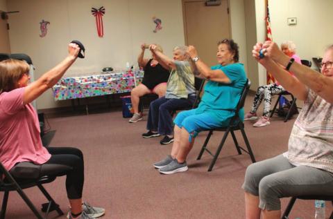 Debbie Brown demonstrates for the participants of Tuesday morning exercise. From right; Vickie Carr, Gloria Aguayo, Mareta Ryan, and Donna Lann in front with Barbara Baker in background.
