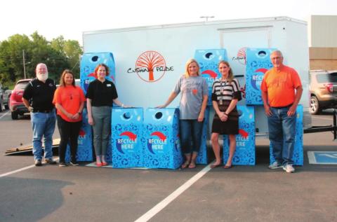 From left stands Chris Hubbard, Laura Green, Dr. Melissa Amon, Brook Holcomb, Jessica Wood, and Richard Thackray with the recycle lend bins that will be dispersed across the Cushing Public Schools property in an eff ort to promote recycling.
