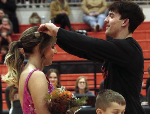 Blaze Berlowitz crowns Cushing 2023 Homecoming Queen Tatum Caulfield during the coronation ceremony at halftime Friday, Jan. 13.
