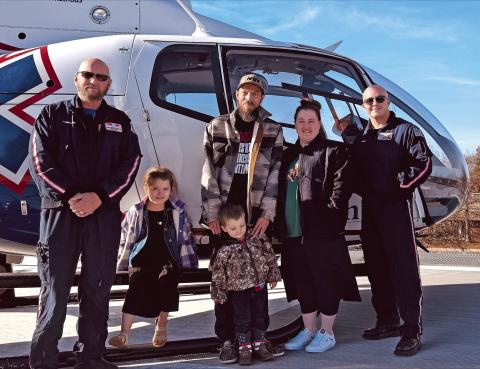 Myles Dobson and his family recently visited the MedFlight crew who transported and provided critical care to him during a flight from Stroud to OSU Medical Center in Tulsa recently. Pictured with Dobson and his family are flight nurse Matt George and Flight Paramedic Chase Boyd.