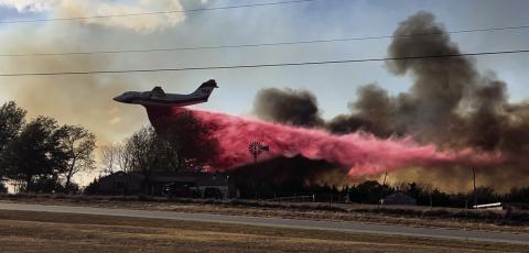 A tanker plane drops Phos-Chek, a fertilizer-based liquid and fire suppressant, on the flames near Schlegel Road. Photo courtesy Jordan Stebens