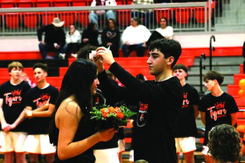 CHS Basketball Homecoming King Kanaan Guerrero places the crown atop the head of Homecoming Queen Ella Nanaeto