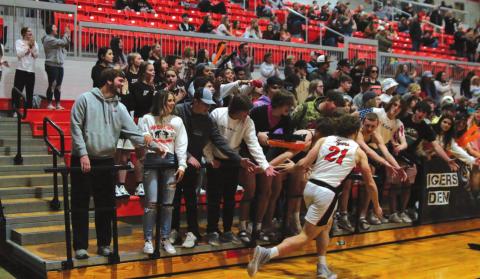 Camden Crooks gets a little energy from the student section during introductions on Friday.