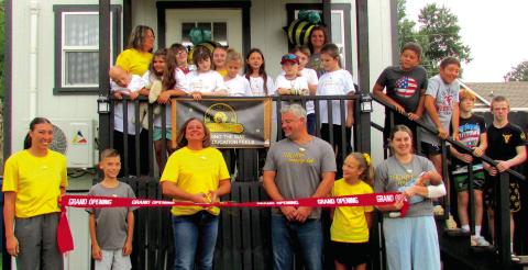 Stevphanie Thurber cuts the ribbon in front of The Hive Learning Lab students and staff marking a milestone for the group. She stands in front with her family — from left; Kinzey Myers, TJ Thurber, Stevphanie, Terry Thurber, Addie Thurber, and Kaylea Ballard.