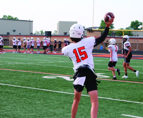 Ethan Evans gets some throws in with receivers at team camp in Cushing on Thursday. Photo by Kaleb Tadpole