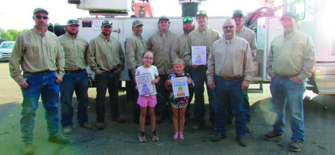 The City of Cushing power distribution team held a coloring contest for the students at Cushing Upper and Lower Elementary. First, second, and third place winners were selected by team members and awarded their prizes last week during Public Power Week. Pictured are city workers Dwayne Abbott, Travis Oaks, Gavin Weatherly, Brendan Campbell, Seth Campbell, Brandon Harris, Sam Rhymer, Josh Moore, Electric Superintendent Mike Stark, and Doug Biswell with the winners of the contest. CUE winners: First place Tat