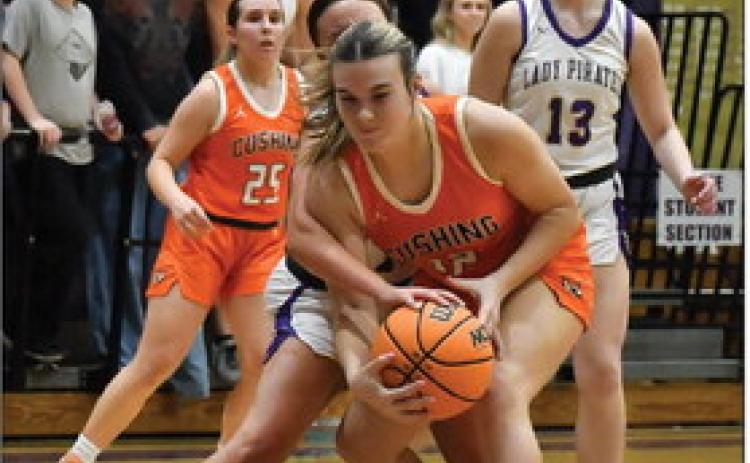 Gracyn Presley battles to maintain possession under the rim. The Cushing Lady Tigers are struggling this season with a record of 2-11.