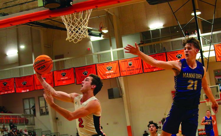 Lane Wood makes a reverse layup. Photos by J. D. Meisner