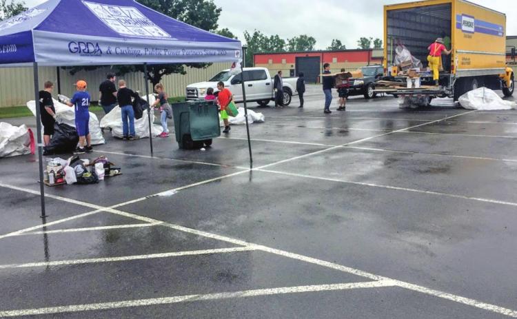 Volunteers at the first recycling event sort through items that have been dropped off.