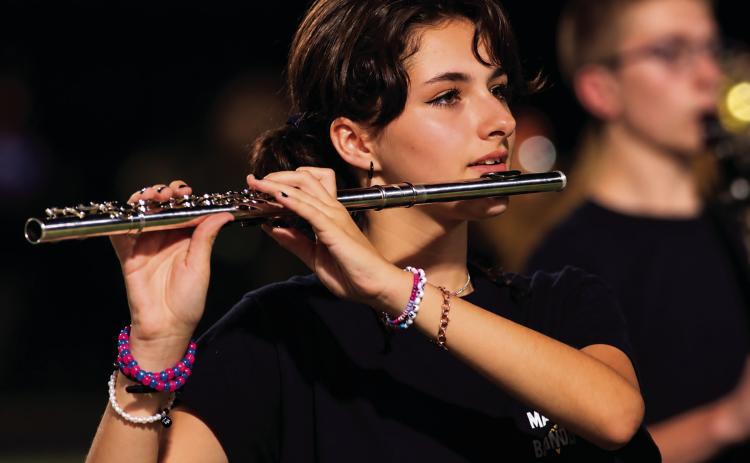 Sophomore flutist Miley Donathan performs with the CHS marching band during the halftime performance Friday, Sept. 4. Photo by J. D. Meisner.