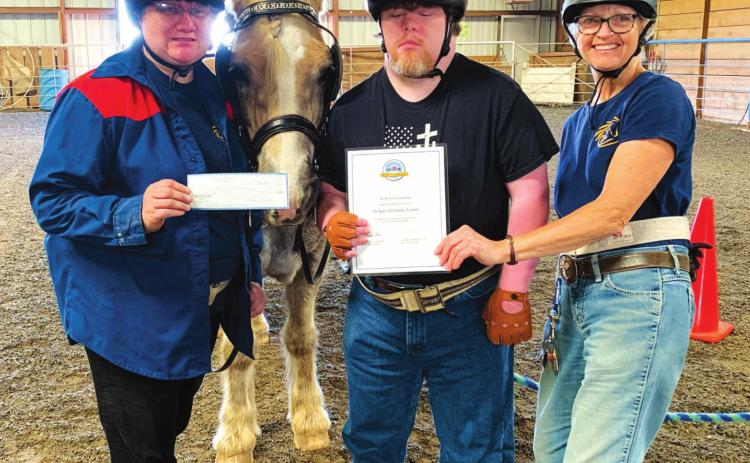 Holly Hulsey, Michael Lawrence and Right Path Founder Leslie Kirkland display the new helmets provided through a grant from MFA Oil Foundation.