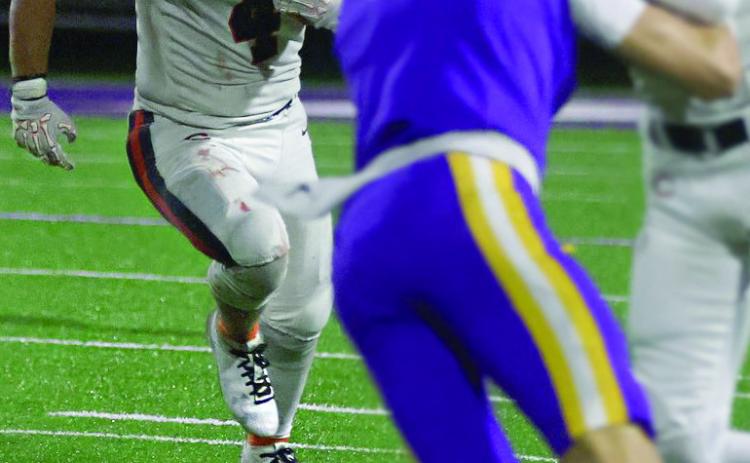 Senior Kellen Fry runs past Pirate defenders.