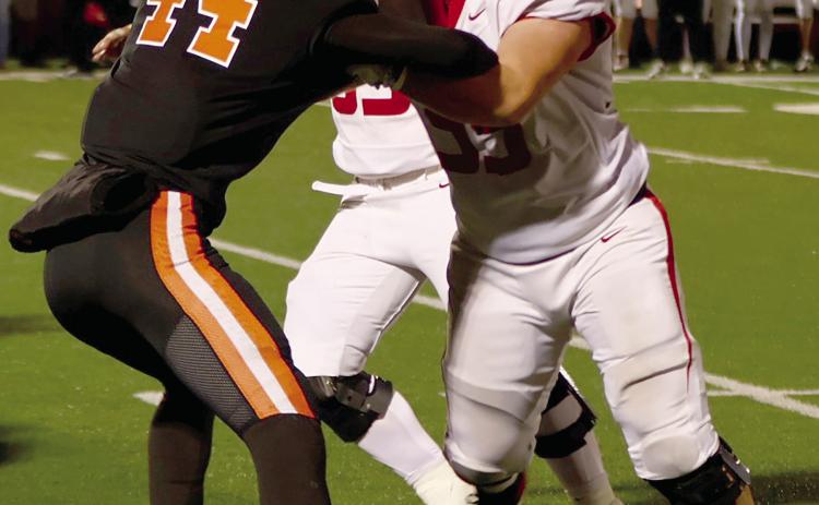 Hunter Joiner stands off with two Elgin defenders during Friday’s semi-final game at Putnam City. Photo by Sylvia Danyele