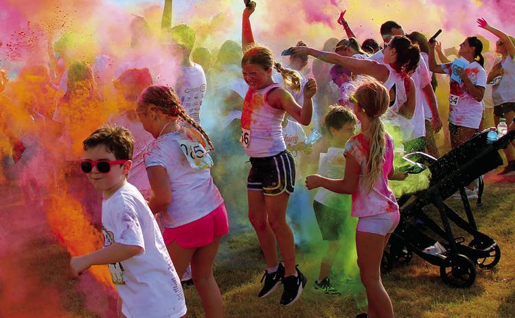 Participants in the Cushing Geographic Club’s Do or Dye fundraiser color run cause a color explosion in Memorial Park Saturday, Aug. 16 following the race. Photo by Allie Prater.