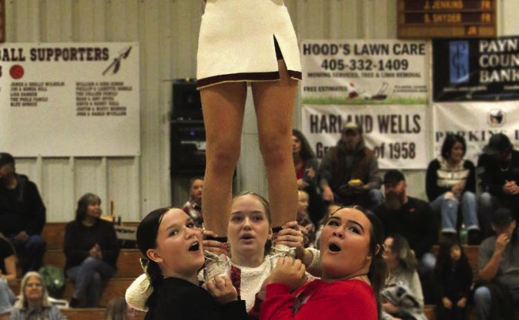 Ripley cheerleaders Tristan Cooper, Taylor Knight, and Annabel Head support Jazmine Toews during the halftime performance at Ripley’s Christmas themed face off with the Earlsboro Wildcats Tuesday, Dec. 19.